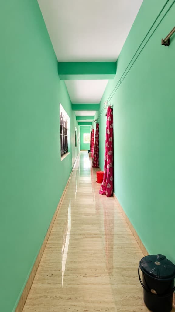 Clean interior corridor with polished floors at Anandamoyee Guest House