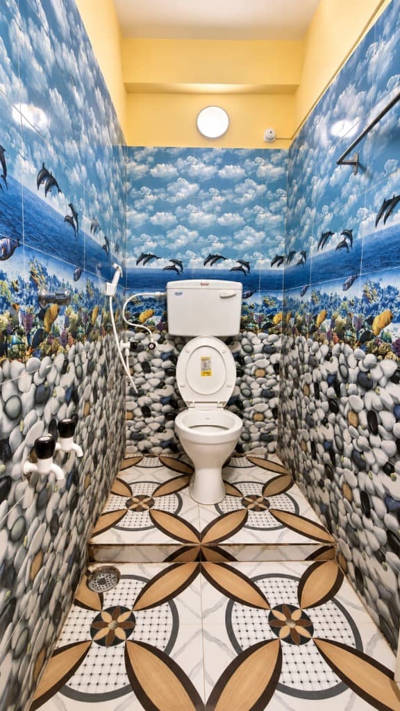 Attached modern western bathroom with tiles at Anandamoyee Guest House